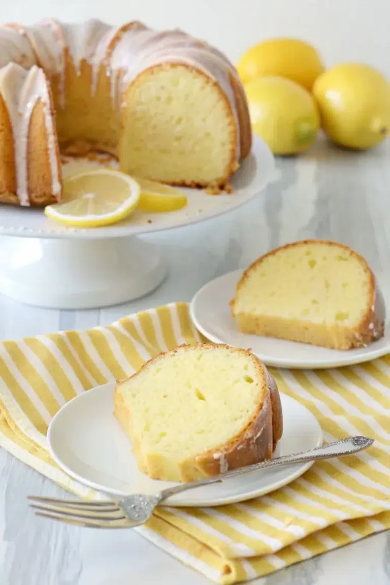 Moist lemon Bundt cake sliced and served on white plates